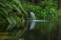 Water flowing from a pipe. Free public domain CC0 image.