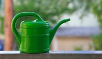 Watering can in garden. Free public domain CC0 photo.