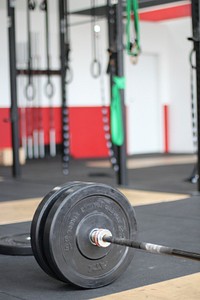 Closeup on weight plates on bar in gym. Free public domain CC0 image.