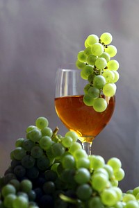 Glass of wine and green grapes. Free public domain CC0 photo.