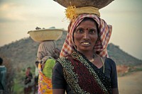 Indian woman carrying basket on head - unknown date & location 