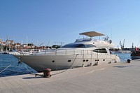 Yacht docking at port. Free public domain CC0 photo.