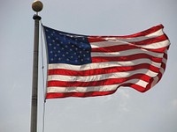 American flag waving against sky. Free public domain CC0 photo.