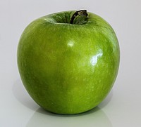 Closeup on green apple on white background. Free public domain CC0 photo.