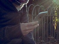 Student checking phone. Free public domain CC0 photo.