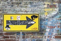 Arrow sign on brick wall. Free public domain CC0 photo.