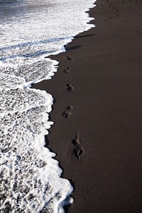 Waves crashing into black sand. Free public domain CC0 photo.