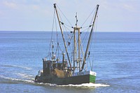 Green fishing boat sailing. Free public domain CC0 photo.