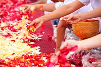 Flower petals on red mat. Free public domain CC0 photo.