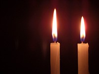 Burning candle in the dark. Free public domain CC0 image.