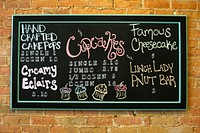 Menu board on brick wall. Free public domain CC0 image.