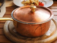 Closeup on copper pan with lid on kitchen table. Free public domain CC0 image.