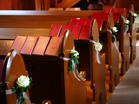 White roses on pews. Free public domain CC0 image.