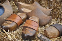 Wooden shoes or clogs on hay . Free public domain CC0 image.