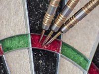 Closeup on darts on dartboard. Free public domain CC0 photo.