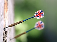 Closeup of darts on wall outdoors. Free public domain CC0 photo.