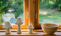 Stone mushrooms, decorations, and bowl by the window. Free public domain CC0 image