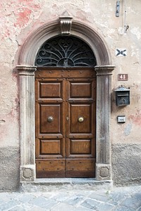 Arched wooden door, architecture. Free public domain CC0 photo.