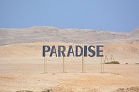 Paradise sign on beach. Free public domain CC0 image.