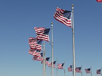 American flag waving against blue sky. Free public domain CC0 photo.