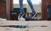Man jumping over puddle. Free public domain CC0 photo.
