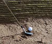 Closeup on golf club head and ball in soil. Free public domain CC0 image.