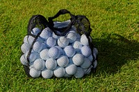 Many golf balls in net bag. Free public domain CC0 photo.