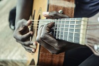 Musician playing guitar, music background.Free public domain CC0 photo.