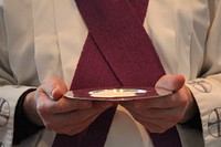 Priest holding Eucharist. Free public domain CC0 image.