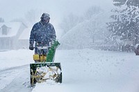 Free man shoveling snow with machine photo, public domain winter CC0 image.