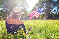 Free blonde woman holding American flag image, public domain CC0 photo.