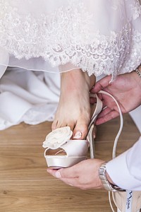 Bride putting on shoe. Free public domain CC0 photo.