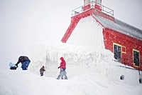 Family playing in the snow. Free public domain CC0 photo.