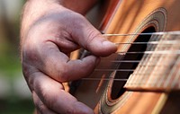 Musician playing guitar, music background.Free public domain CC0 photo.