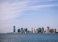 Landscape view of ocean with city skyscrapers in the background