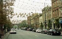 Day view of city market road decorated with garland Lights