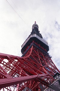 Low angle view of Tokyo Tower with cloudy sky in the background