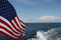 American flag, blue sky. Free public domain CC0 photo.