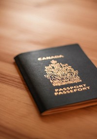 Passport book on wooden table. Free public domain CC0 photo.