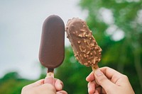 Chocolate ice cream held by hands. Free public domain CC0 photo.