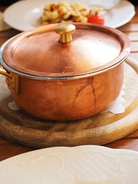 Closeup on copper pan with lid on kitchen table. Free public domain CC0 image.