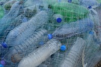 Plastic bottle in fishing net. Free public domain CC0 photo.