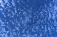 Blue sky background with clouds. Free public domain CC0 photo.