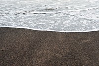 Waves crashing into black sand. Free public domain CC0 image.