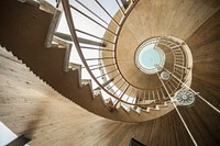 Looking up at a spiral staircase with metallic hand-rails. Free public domain CC0 photo.