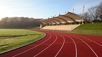 Empty running track and field during daytime. Free public domain CC0 photo.