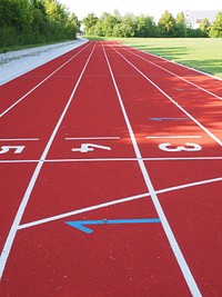 Empty running track and field during daytime. Free public domain CC0 photo.