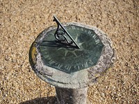 Sundial device, telling time by the sun. Free public domain CC0 photo.