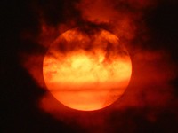 Red cloudy sky with sun. Free public domain CC0 photo.