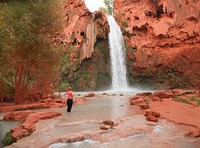 A woman wades in pools below Havasu Falls, one of five Havasupai waterfalls deep in Arizona&rsquo;s Havasu Canyon, an offshoot of Grand Canyon National Park but on lands administered by the Havasupai Indian Tribe.
